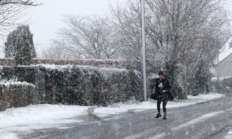 Ciara McMahon makes her way through heavy snow on Thursday morning in Emo, Co Laois. Photograph: Laura Hutton/The Irish Times