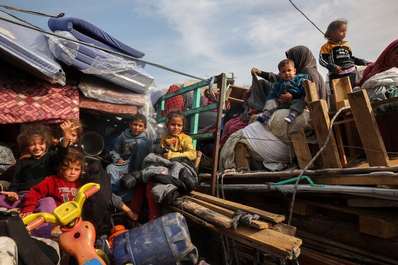 Displaced Palestinian children sit on the back of trucks waiting along Salah al-Din road in Nuseirat as people make their way to the northern part of the Gaza strip on Tuesday. Photograph: Eyad Baba/AFP via Getty Images