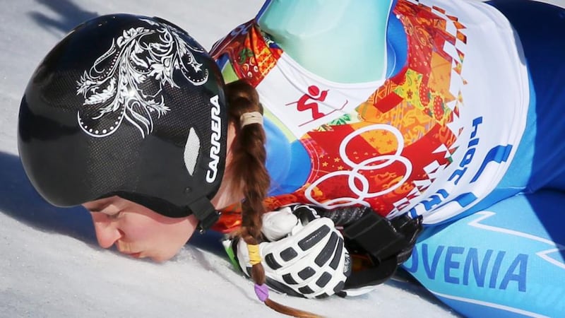 Tina Maze of Slovenia kisses the snow in the finish area after her run in the women’s downhill race at the Rosa Khutor Alpine Centre, which saw her share the gold medal with Dominique Gisin of Switzerland. Photograph:  Fredrik Von Erichsen/EPA