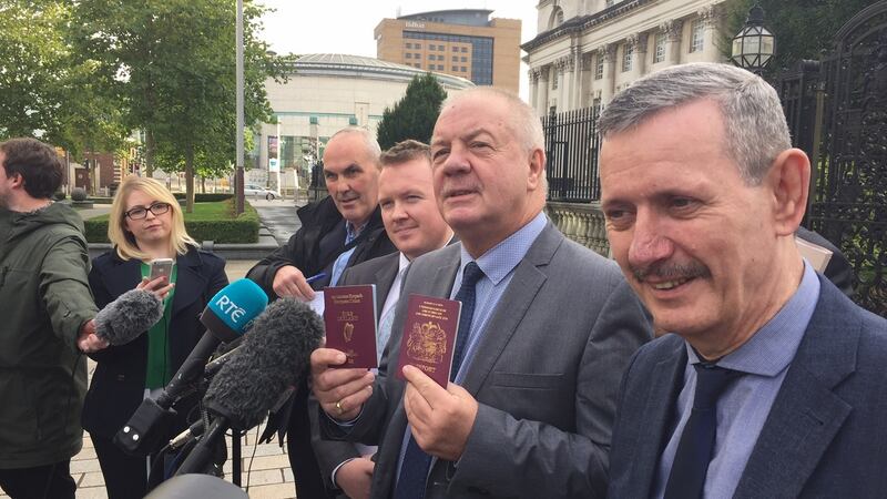 Victims’ campaigner Raymond McCord - who was behind one of two applications challenging the outcome of the Brexit referendum -  displays the  Irish passport he received on Thursday, together with his British passport, outside the High Court in Belfast.