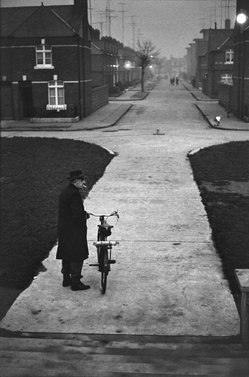 MAN WITH BIKE ON THE STREET