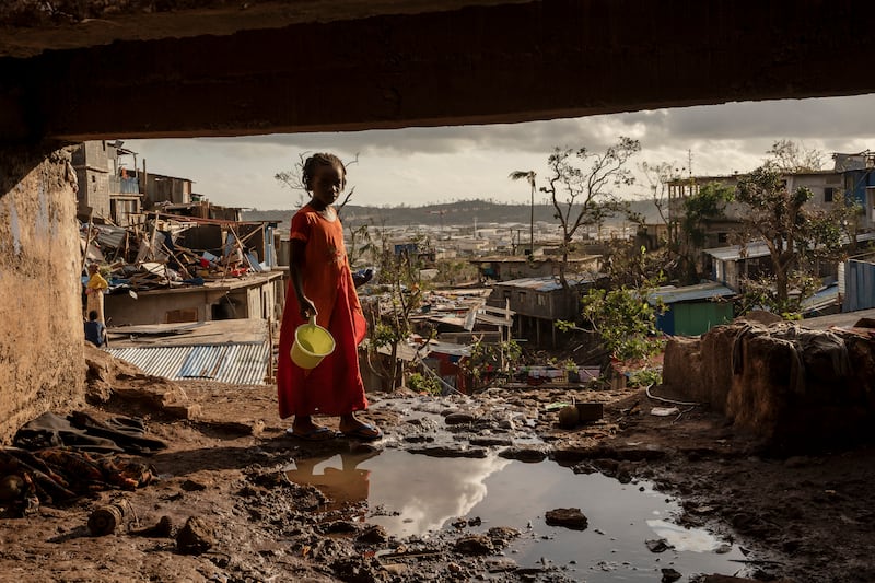 A young girl stands amid the devastation after Cyclone Chido. Photograph: Adrienne Surprenant/AP