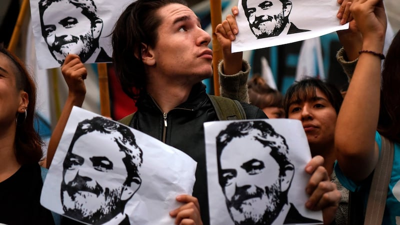 People hold portraits of Brazilian former president (2003-2011) Luiz Inacio Lula da Silva as they demonstrate against his detention outside the Brazilian embassy in Buenos Aires, Argentina, on Friday. Photograph: Eitain Abramoviceh/AFP