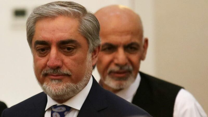 Afghan presidential candidates Abdullah Abdullah (left) and Ashraf Ghani attend a ceremony after signing a power-sharing agreement at the presidential palace in Kabul yesterday. Photograph: EPA/Jawad Jalali