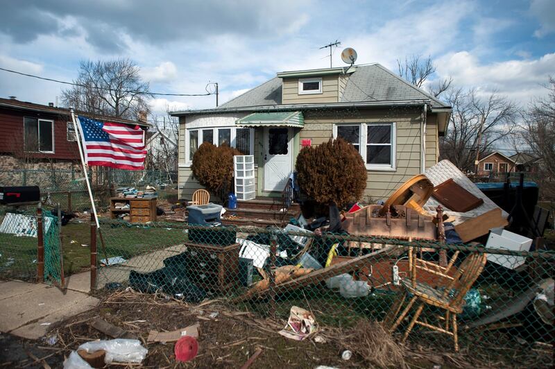 Debris surrounds a house that was damaged by Hurricane Sandy in  New York in 2013. Photograph: Karsten Moran/The New York Times