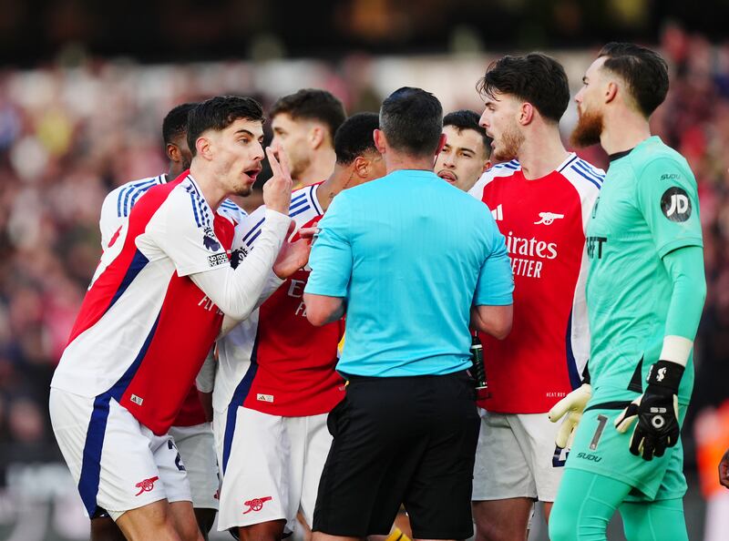 Arsenal players confronting referee Michael Oliver after showing Myles Lewis-Skelly the  red card. Photograph: Mike Egerton/PA Wire
