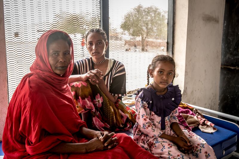 Haji Hessin (48) sits with her daughters in the hospital in Renk, South Sudan. The previous day she found out that one of her relatives was killed