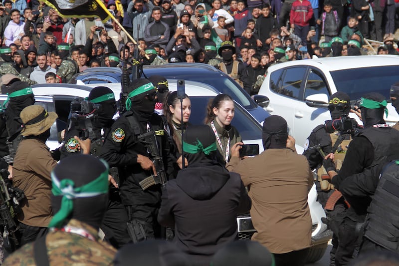 Israeli hostages Naama Levy (C-R) and Karina Ariev (C-L) walk before being delivered to the International Committee of the Red Cross by Hamas militants in Gaza City. Photograph: EPA