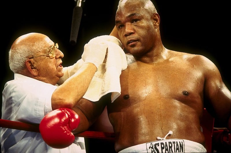 George Foreman receives treatment  during his bout with Shannon Briggs in November 1997.  Briggs won the bout by way of decision after 10 rounds. Photograph: Al Bell