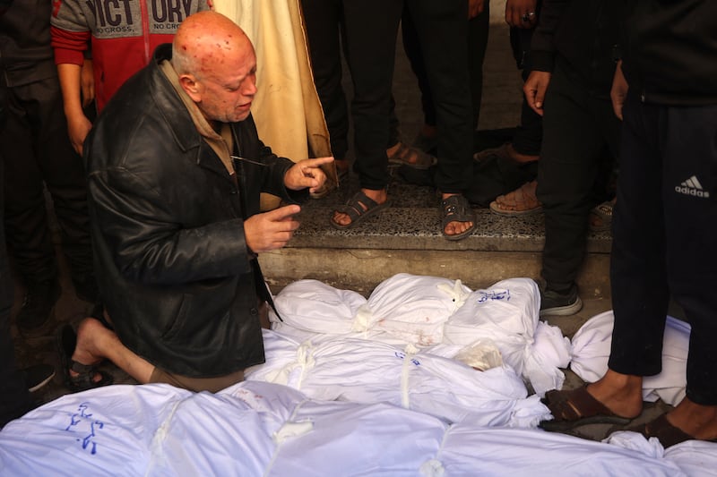 A man mourns over shrouded bodies during a funeral at Al-Ahli Arab hospital in Gaza city on December 17th after dozens were killed in Israeli attacks. Photograph: Omar al-Qattaa/AFP/Getty