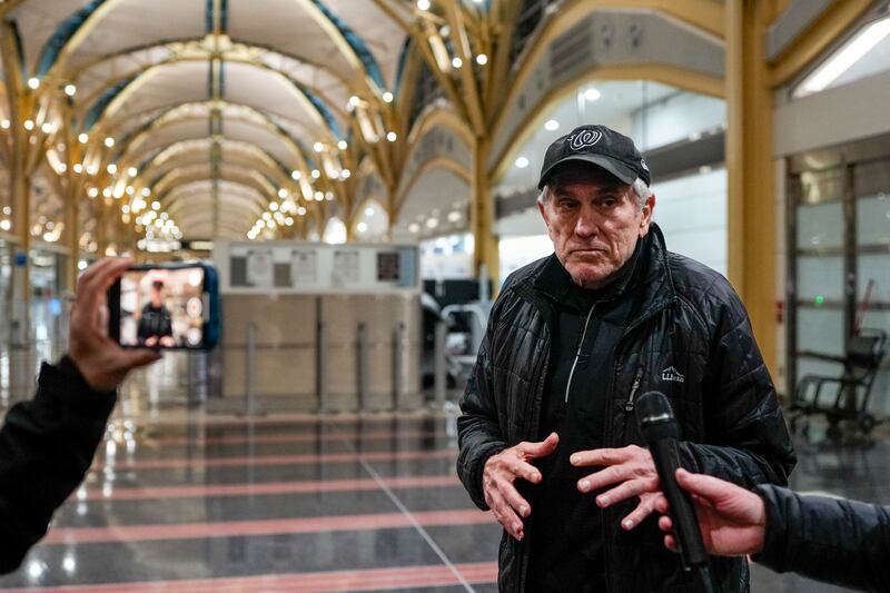 A man speaks to reporters as he looks for his son at Ronald Reagan Washington National Airport. Photograph: Kent Nishimura/The New York Times                      