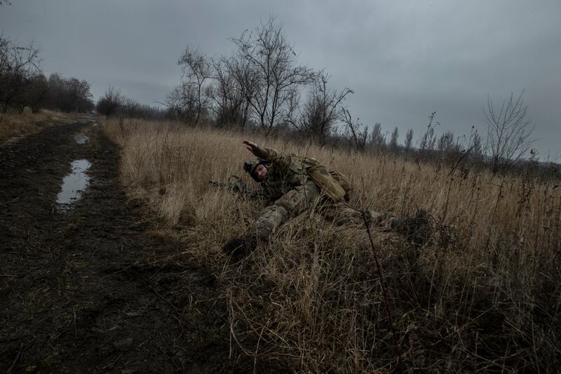 A Ukrainian soldier with the 79th Air Assault Brigade takes cover from incoming Russian bombardment in an area of Marinka, in eastern Ukraine. Photograph: Tyler Hicks/New York Times