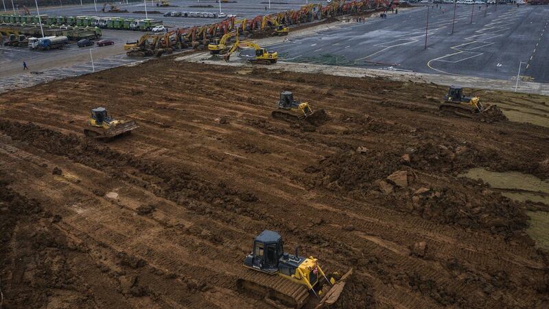 Bulldozers are used at a  construction site of a field hospital  in Wuhan, Hubei province, China. Wuhan Leishenshan hospital will be completed on February 5th, with a capacity of 1,300 beds for coronavirus patients, according to the government. Photograph: Getty