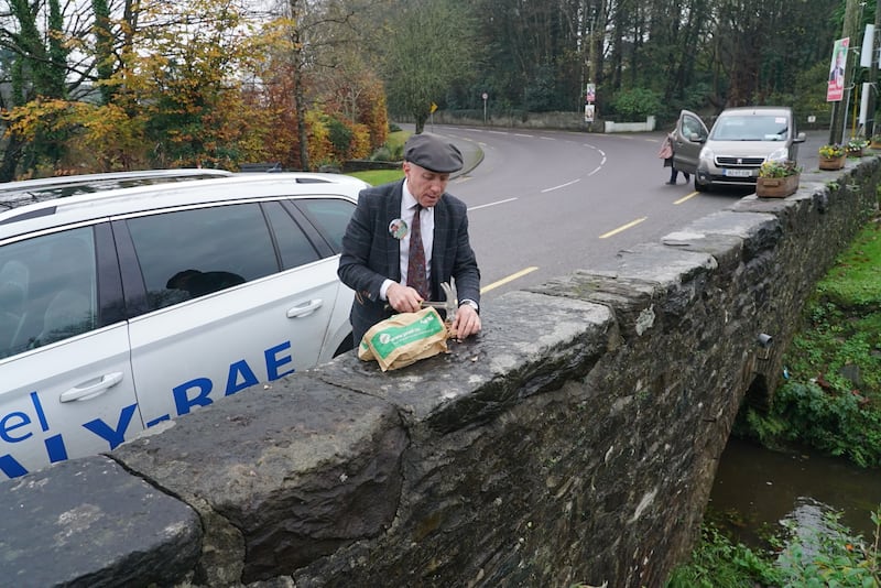 Michael Healy-Rae takes a break from the campaign trail to hammer nuts on a bridge in Milltown, Co Kerry. Photograph: Enda O’Dowd