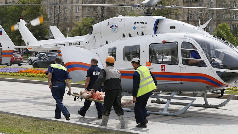 Rescuers carry an injured passanger to an ambulance helicopter from the ‘Park Pobedy’ metro station. Photograph: Yuri Kochetkov