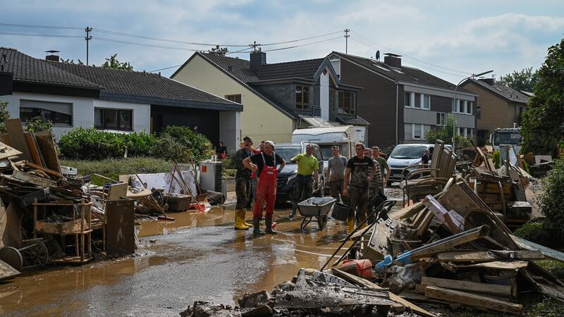 Volunteers clean the streets around the Haus Lebenshilfe care home, where 12 sleeping residents died in the flooding, in Sinzig, Germany, on Saturday. Photograph: The New York Times