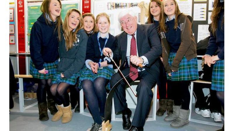 Batt O’Keeffe tries out a musical saw from a project by Máirín Ryan (centre) with students from Our Lady’s Bower, Athlone. Photograph: Alan Betson