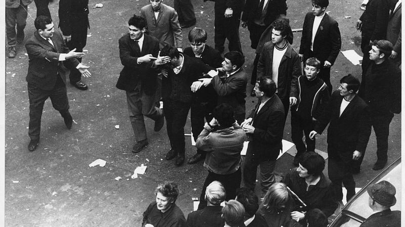 A casualty of the police baton charges at the Derry civil rights march in October 1968 is led away after the clash in Duke StreetI. Photgraph: The Irish Times