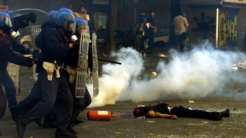 Violent clashes: police storm past the body of a protester who was shot and killed by carabinieri during rioting at a G8 summit in Genoa in July 2001. Photogaph: Dylan Martinez/Reuters