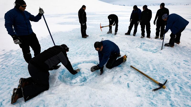 A group of explorers extract blue ice blocks near the Glaciar Union camp in the Ellsworth Mountains, Antarctica, in  November 2018. Photograph: EPA