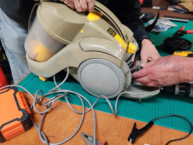 A vacuum cleaner being repaired