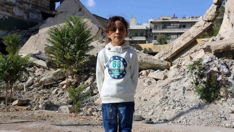 Bana al-Abed, seen in front of ruined buildings in eastern Aleppo. Photograph: Thaer Mohammed/AFP/Getty Images