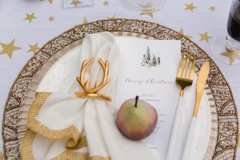 The Designed Table: Tablecloth, gold placemats, linen napkins and gold antler napkin rings