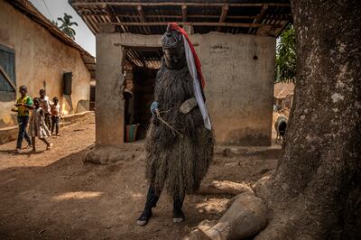 A Bondo devil, which is a key figure in women's genital-cutting rituals, in Port Loko, Sierra Leone.