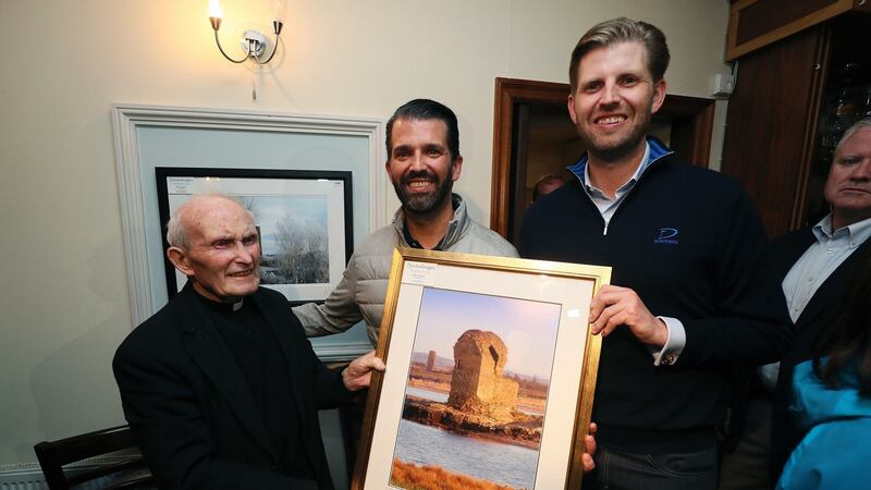 Donald Trump jnr (centre), and Eric Trump (right) with Fr Joe Haugh (left) in Igoe’s Pub in the village of Doonbeg, Co Clare. Photograph: Brian Lawless/PA