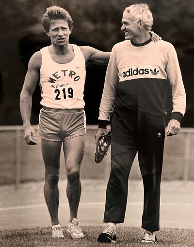 Eamonn Coghlan limps off the track supported by Noel Carroll following the National Championships in Santry in 1984