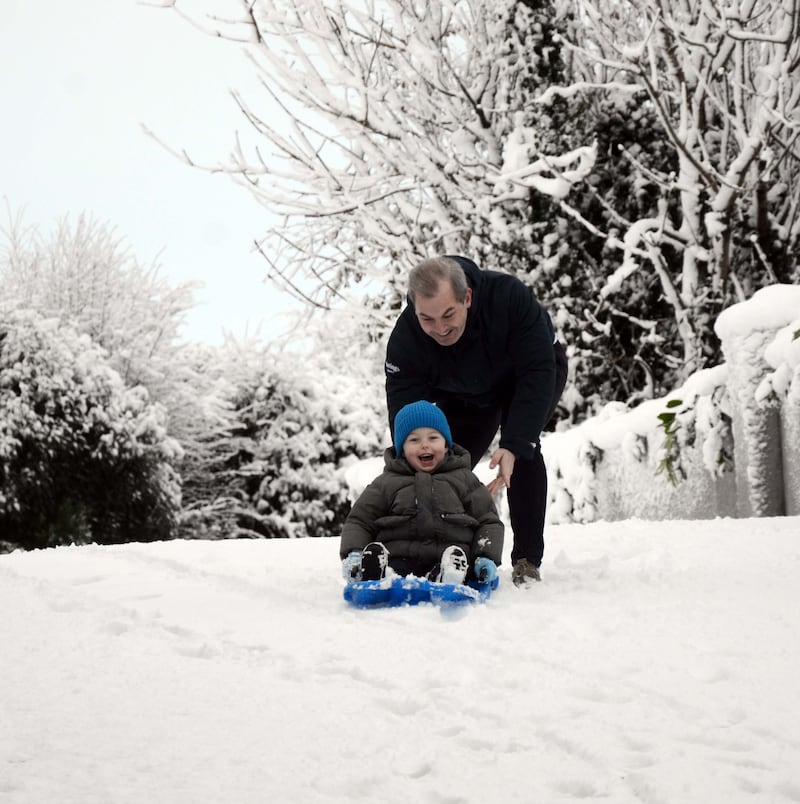 Brian Moran and his son Rian made the most of the heavy overnight snow in Westport, Co Mayo. Photograph: Paul Mealey