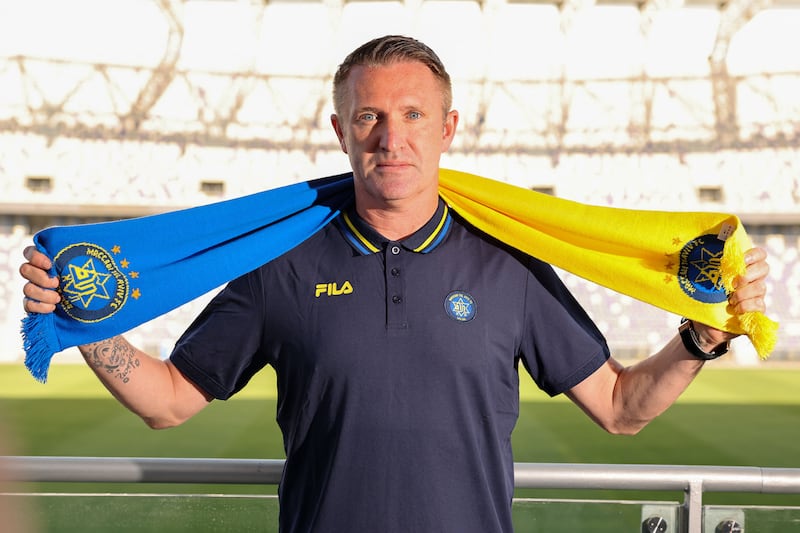 Robbie Keane with the scarf of Maccabi Tel Aviv in June 2023 after signing a two-year head coach contract with the Israeli team. Photograph: Jack Guez/AFP via Getty Images