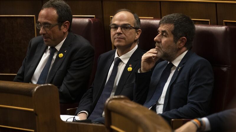 Jailed Catalan separatist leaders Josep Rull (left), Jordi Sanchez (right) and Jordi Turull (centre) attend to the opening plenary session at the Spanish Parliament in Madrid. Photograph: Pablo Blazquez Dominguez/ Pool/Getty Images