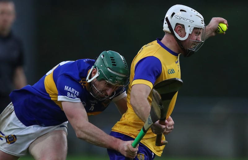 Paul O’Dea of Na Fianna gathers possession ahead of Clough Ballacolla's Willie Dunphy. Photograph: Leah Scholes/Inpho