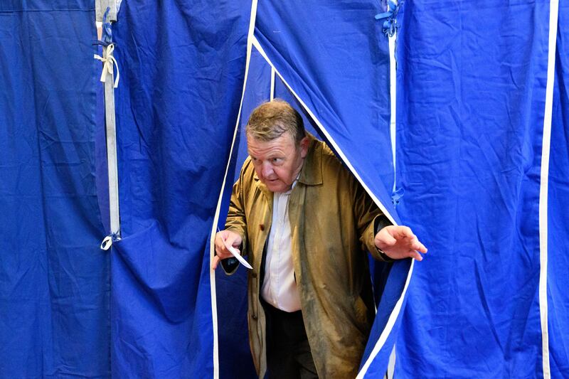 Former Danish prime minister and leader of the liberal Moderates Party Lars Loekke Rasmussen leaves a booth after voting in the referendum on the abolition of the defence opt-out.