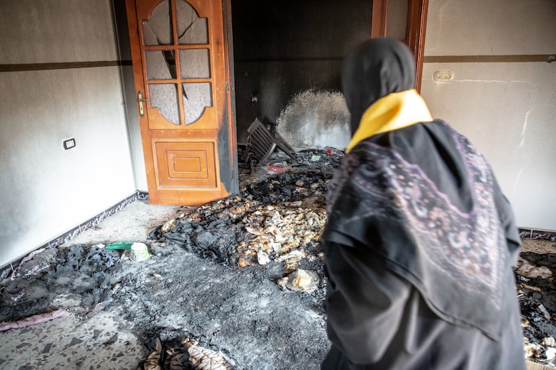 Anisa walks through what remains of her home in Aitaroun, south Lebanon. Photograph: Sally Hayden