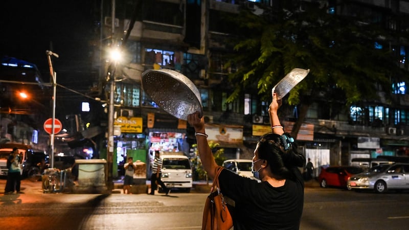 A woman clatters pans to make noise after calls for protest went out on social media in Yangon on February 3rd. Photograph: STR/AFP via Getty Images