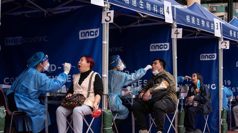 People are tested for Covid-19 at a temporary testing site in Hong Kong. Photograph:  Louise Delmotte/AFP via Getty Images