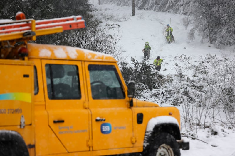 An ESB repair crew fixing a broken electricity line due to a fallen tree  in the hills near Castlewarren near Kilkenny City during heavy snow fall and weather warnings. Photograph: Alan Betson

