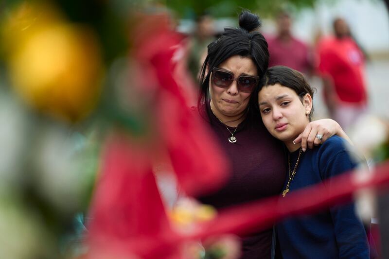 People gather at a vigil for victims of a mass shooting the day beforehand at the entrance to Allen Premium Outlets in Allen, Texas, on Sunday, May 7th, 2023. Photograph: Cooper Neill/New York Times