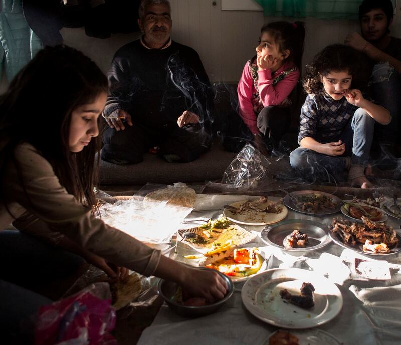 Skaramagas: families eat at the refugee camp near Athens. Photograph: Eirini Vourloumis/New York Times