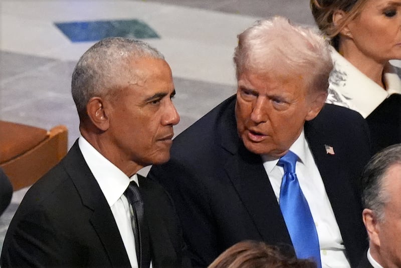 Donald Trump speaks with former president Barack Obama before the state funeral for former president Jimmy Carter. Photograph: AP