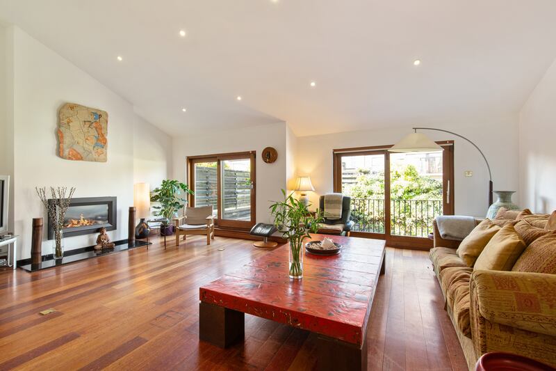 The livingroom has two sets of double doors, one of which opens on to a narrow Juliet balcony and the other on to a roof terrace