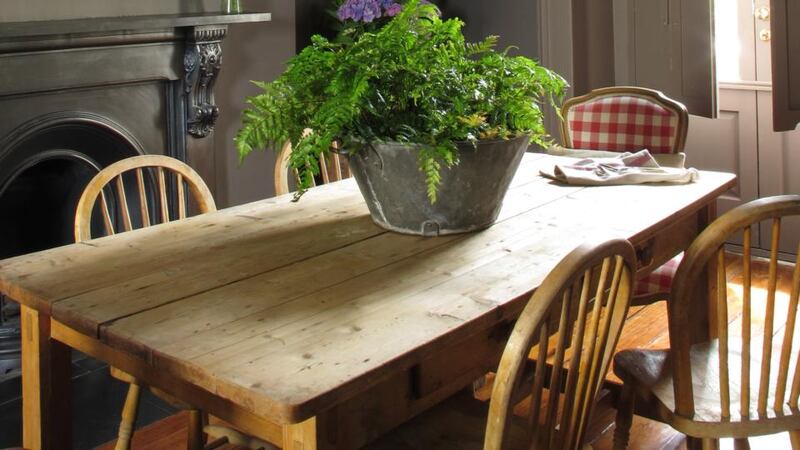 The scrubbed pine dining table and chairs came from a skip. Mac Gowan added a galvanised bucket filled with flowers from the Garden Shop at Mount Usher Gardens