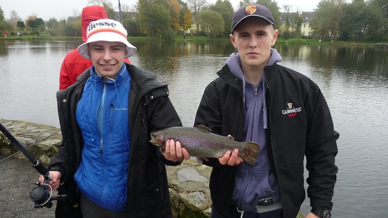 Lee Royal (left), from Corduff outreach programme, with his rainbow trout and Dublin Angling Initiative volunteer Robert Farrington (right), at the Angling for All Facility in Aughrim