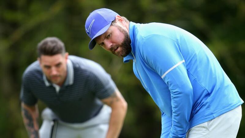 Brian McFadden and Keith Duffy (background) at a pro-am golf tournament this month. Photograph: Alex Pantling/Getty