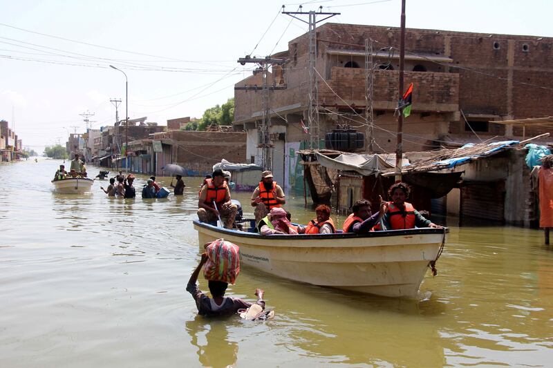 People affected by flooding move to higher grounds in Khairpur Nathan Shah, Dadu district, Sindh province, Pakistan on Friday. Photograph: Waqar Hussein/EPA-EFE