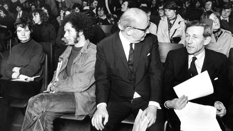 October 21st, 1974: Mairin de Burca and Eamonn McCarin apparently keeping their own counsel while Constantine Fitzgibbpn speaks to Lord Brookeborough during the Historical Society debate in Trinity College, Dublin. Photograph: Pat Langan/The Irish Times