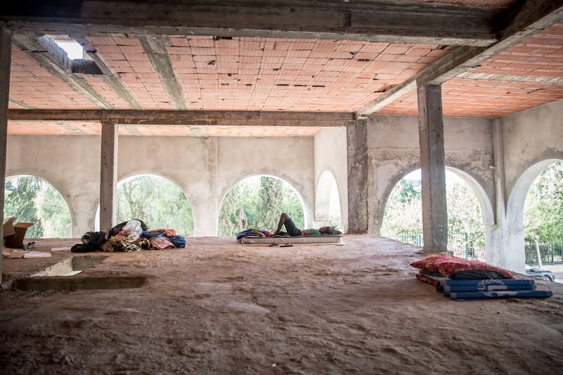 Tents and mattresses in an unfinished building in Tunis which is home to people from Sudan and Somalia, many of whom are hoping to cross the Mediterranean Sea to Europe. Photograph: Sally Hayden