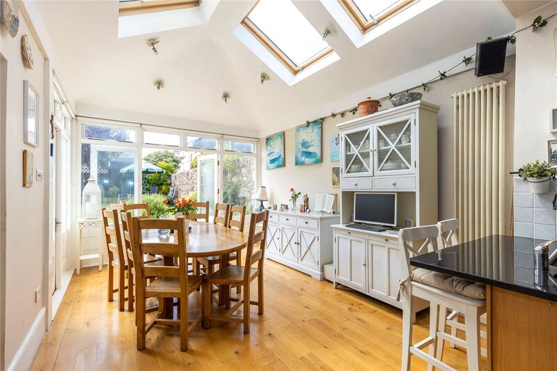 There is a dining area with double doors opening out onto the patio area just below the garden